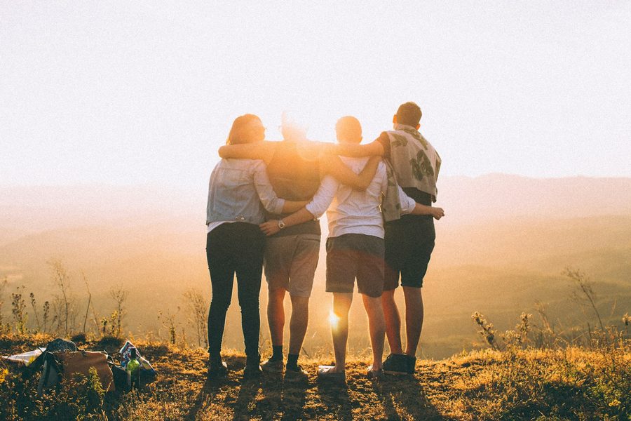 Friends arm in arm at sunset