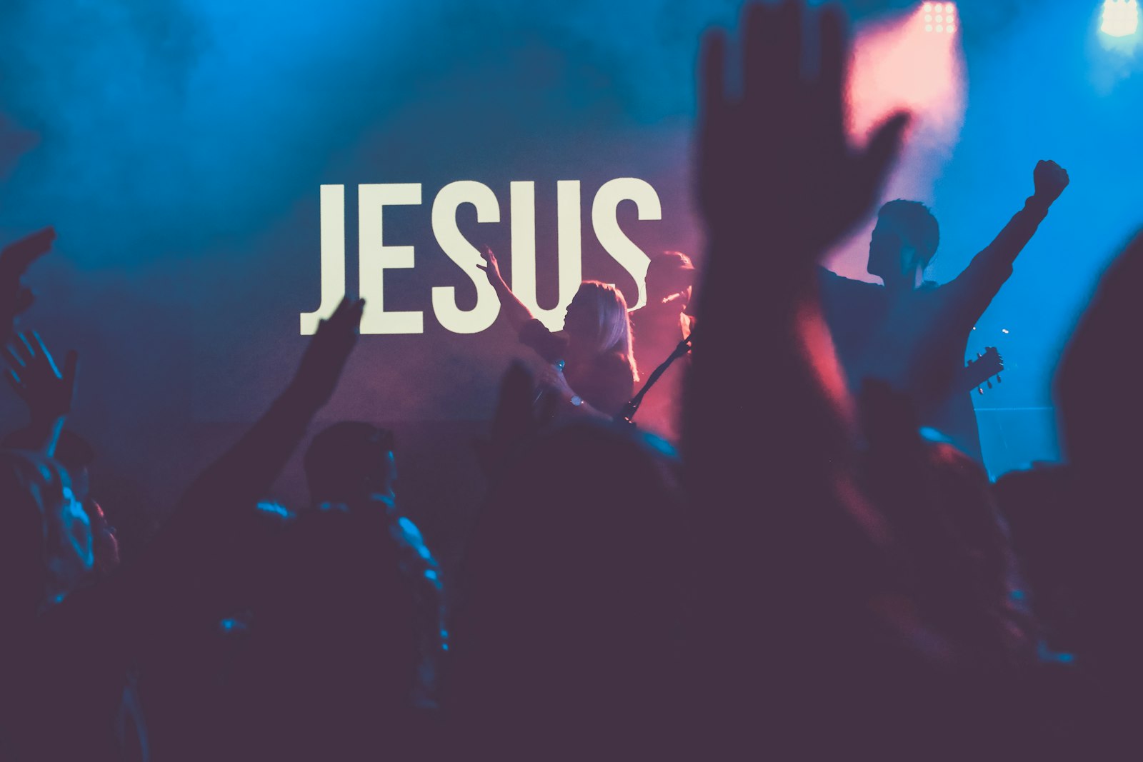 Congregation worshiping Jesus with raised hands